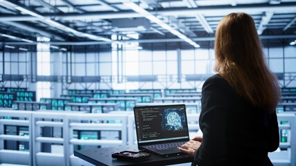 Engineer in data center using artificial intelligence computing simulating human brain thought processes in computerized model. Employee works on laptop with AI machine learning algorithms, camera B