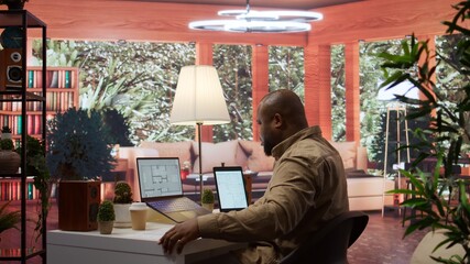 Entrepreneur drafting architectural blueprints for a office space hunt, reviewing property to...