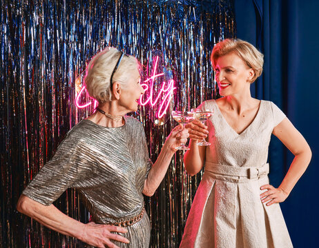 two mature women drinking sparkling wine at the party. Holidays, life event, celebration concept