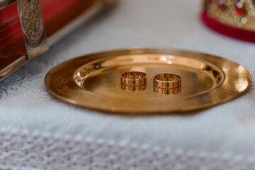 Elegant Wedding Rings on a Decorative Brass Plate