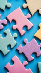 Fototapeta premium Pastel Puzzle Pieces on Blue Background, Teamwork, Problem-Solving Concept. High Angle View