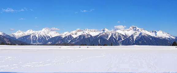 Snowy mountain range against blue sky panorama