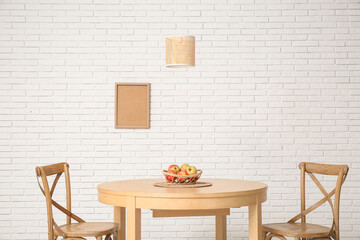 Table with basket of apples in dining room