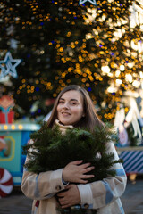 Happy New Year 2025. Vertical photo. Young adult child free white brunette woman on fair with fir...