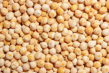 Uncooked Yellow Polished Peas Background. A Culinary Canvas of Dry Yellow Peas, Creating a Lively and Textured Background for Gourmet Cooking. Scattered Raw Polished Peas. Healthy Eating Ingredients