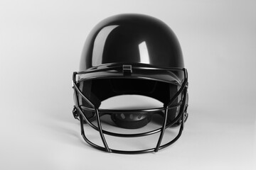 Naklejka premium One black baseball helmet on white background