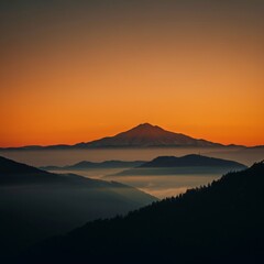 Fototapeta premium Serene sunrise over a misty mountain range