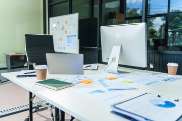 Two young female business consultants work on startup, collaborating on mobile app development social media strategies. whiteboards, documents, they aim to build a successful e-commerce business.