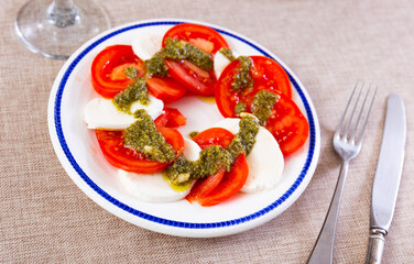 Traditional appetizer of Italian cuisine is Caprese, made from tomatoes, mozzarella, pesto sauce...