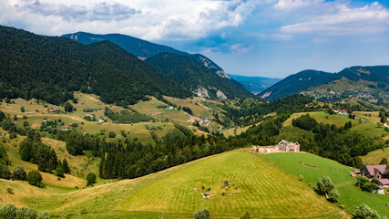 Obraz premium Aerial View of Majestic Mountains and Expansive Sky in Romania