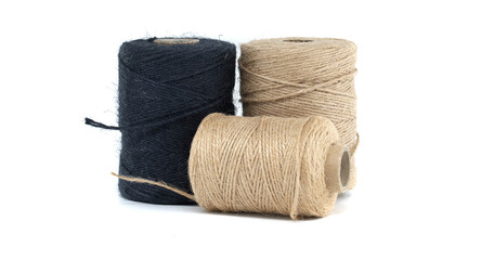 Collection of jute and twine spools on a white background, highlighting natural fiber materials