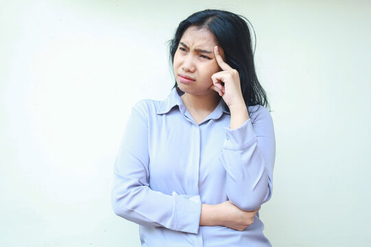 stressed sad asian woman thouch her head thinking problem solution with folded arm and looking away isolated on white