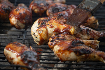 Basting Chicken Legs on the grill