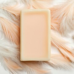 A soft, creamy soap bar on a delicate feather background.
