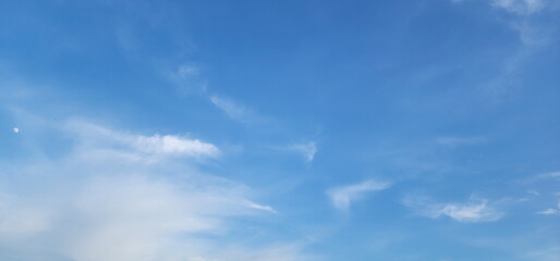  Clear blue sky with some clouds. Sky Blue and white cloud, Thin clouds floating. Elegant empty blue background.  Horizon Spring, Clear Sky. The sky is very bright and the sun is shining
