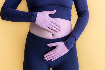 Young female holding belly, caused by either period pain, Endometriosis, pregnacy symptoms, urinary...