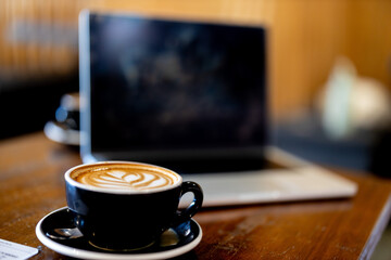 Mug of coffee with latte art. Sit-in cafe dining or restaurant casual style and lifestyle. Work...