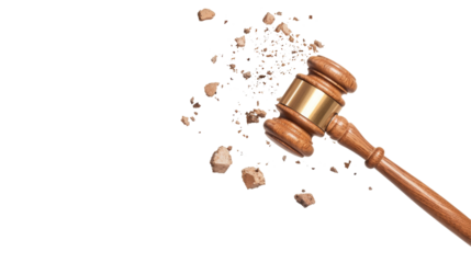 A wooden gavel is striking down, causing debris to scatter, symbolizing justice, authority, and the decisive nature of court rulings.