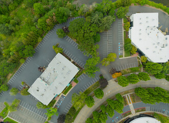 A view of a parking lot with two buildings in the background © Anton