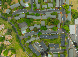 A view of a residential neighborhood with houses and cars parked on the street