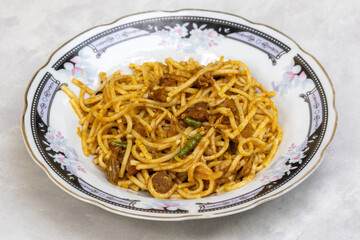 Homemade delicious beef chowmein noodles in a white plate.