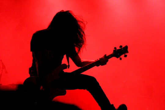 Silhouette of guitar player or guitarist perform on concert stage