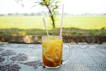 Young coconut ice with palm sugar in a white glass.