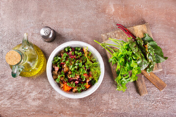Beet salad in bowl over light stone background. Healthy detox salad with beetroot