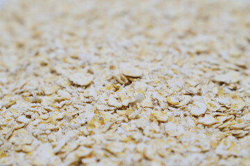 Detail of raw oat flakes. Healthy porridge background.