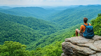 Fototapeta premium Man with Backpack on Mountaintop overlooking Valley Landscape