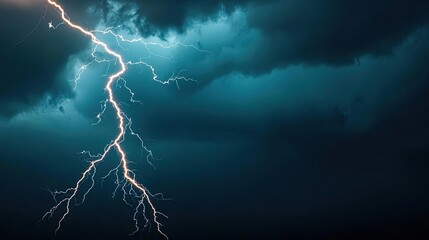 Fototapeta premium Dramatic lightning striking through dark storm clouds.