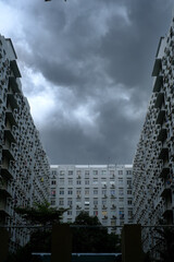 An apartment with black clouds that are about to rain. Bad weather theme