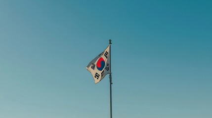 Vibrant south korean flag flutters gracefully against a stunningly clear blue sky backdrop