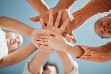Kids, hands together or unity below with blue sky for community, care or trust in support. Low...