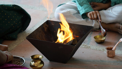 Indian Family Performing Yagya or havan Ritual for Vastu Blessings During Festival, havan kund