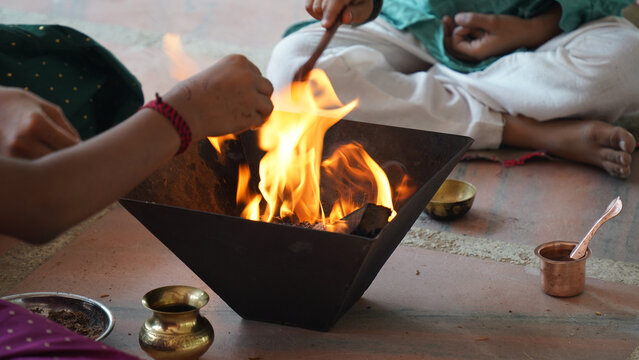 Indian Family Performing Yagya or havan Ritual for Vastu Blessings During Festival, havan kund