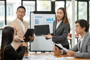 Asian Business Group Chat about graph work Present in meetings, in the office.