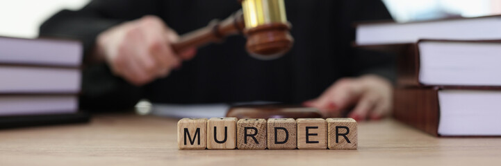 World Murder on wooden blocks and judge knocking gavel