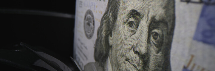 Dollar bill on banknote counter at financial establishment