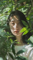 Fototapeta premium Serene Portrait of a Young Woman Amidst Lush Greenery with Sunlight