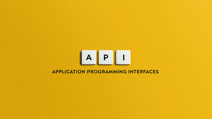 Fototapeta premium API, application programming interface on a yellow background with three wooden blocks text API