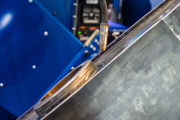 Multi axis robot welding steel. Industrial welding robot and working with metal parts. Robot welds steel. Welding head. Welding robot. CNC welding. Robotization and automation of the welding process.