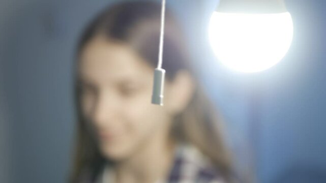 Pull Switch On Off, Turning the Light On a Led Bulb, Turn On the Light in a Dark Room, Girl Turns the Light On at Home