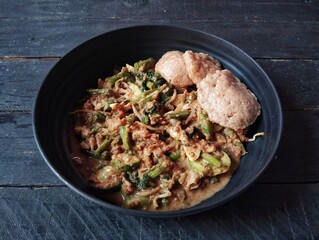 Gado gado on the wooden table. Gado-gado is a dish consisting of vegetables seasoned with peanut sauce and so on.