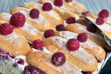 A tray of pastries with raspberries on top