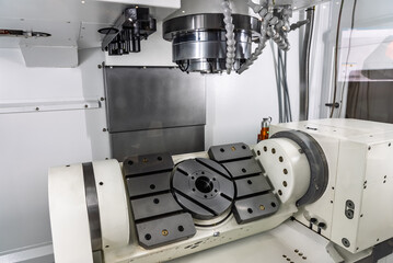 Five axis milling machining center. Interior of a 5 axis milling machine. Milling machine with a rotary table. Multi axis CNC machine.