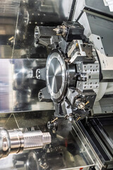 Inside view of a cnc machine. CNC lathe interior.Cnc machine. The CNC lathe machine or Turning machine. Turning numerical control machine with tools and chuck.