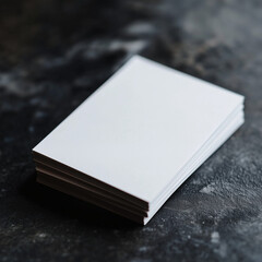 Fototapeta premium Stack of blank business cards on dark textured surface