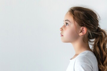 Fototapeta premium Girl looking sideways with empty space for your message or logo placement.