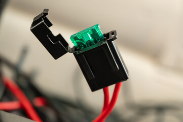 Flat fuse as a plug-in fuse in a fuse housing installed in the supply line of an electrical consumer